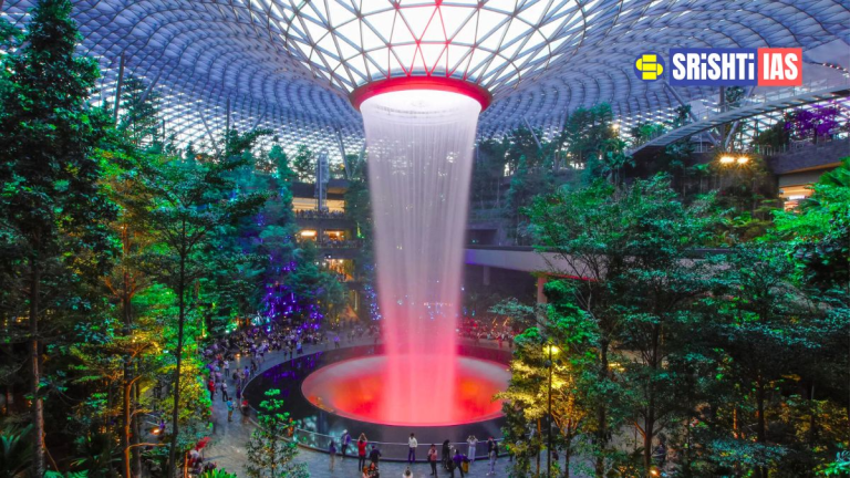 Interior view of Singapore Changi Airport featuring the Rain Vortex and indoor gardens